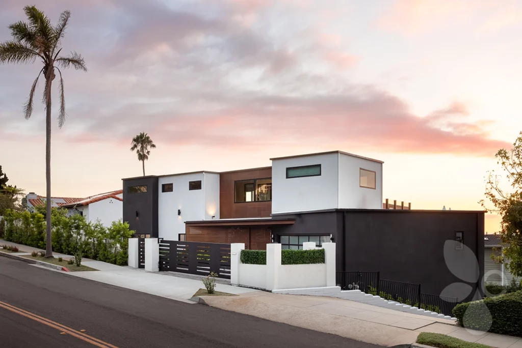 Front of home with street in front and sunset behind.