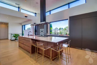 Bar seating on the edge of a kitchen remodel, with full kitchen backsplash behind it.