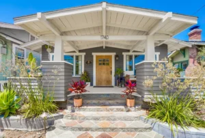 Charming home exterior showcasing a well-maintained porch and landscaping, ideal for inspiration when creating a checklist for planning a major renovation